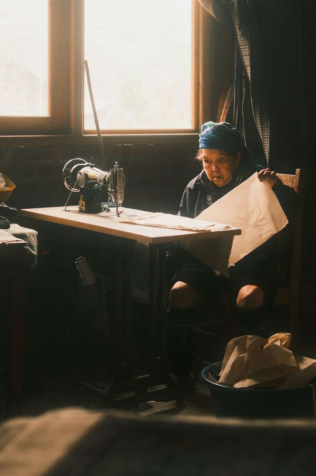 Editor reviewing printed newspaper pages at a desk